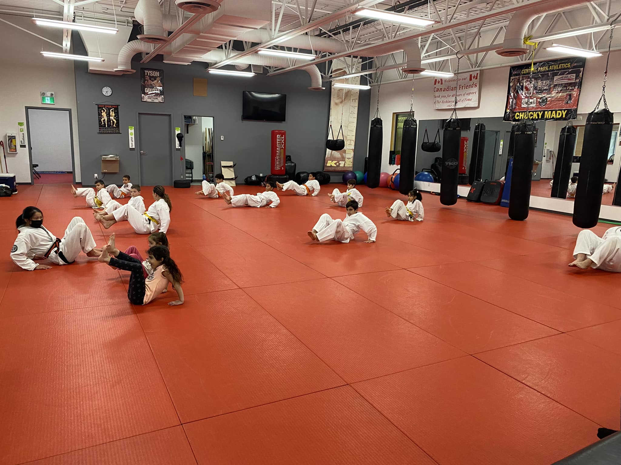 Students practising together on the red dojo floor
